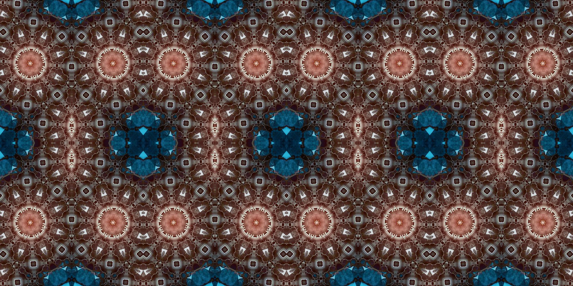 A seamless, intricate abstract pattern featuring repeating circular and geometric shapes in shades of brown, bronze, and teal blue. Resembles a kaleidoscope or mandala.